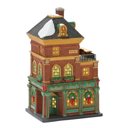 Decorative model of a three-story building with Christmas decorations on a white background