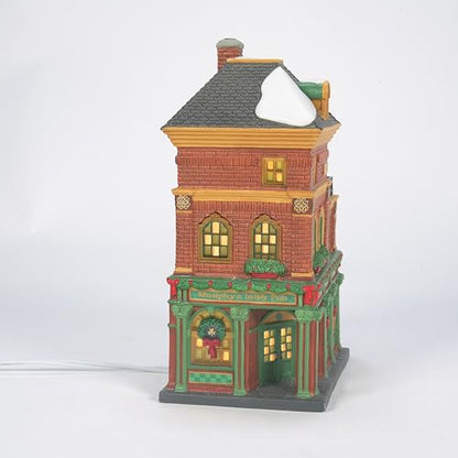 Decorative model of a two-story building with lit windows on a white background