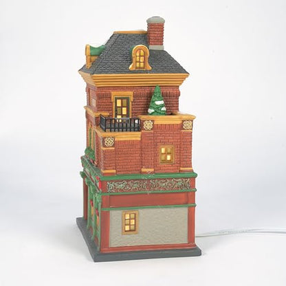 Decorative model of a two-story building with a small tree on a white background